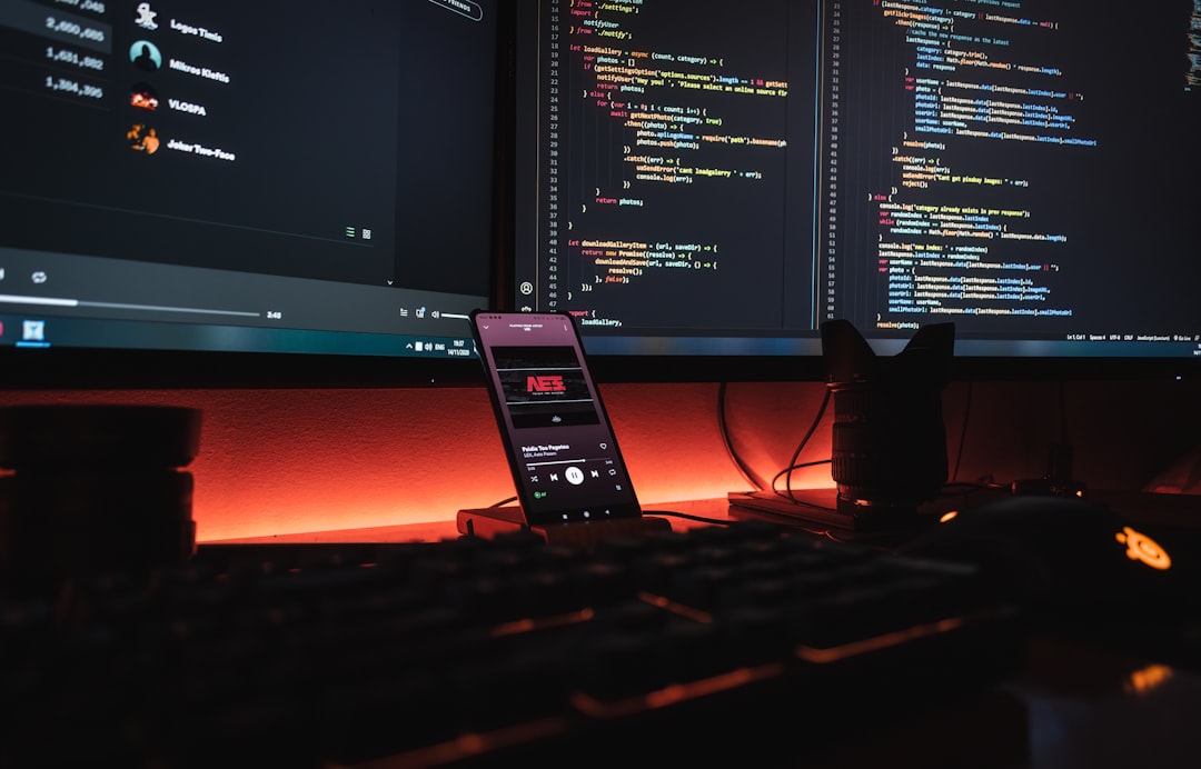 Developer working with multiple screens showing code and AI chat interfaces side by side